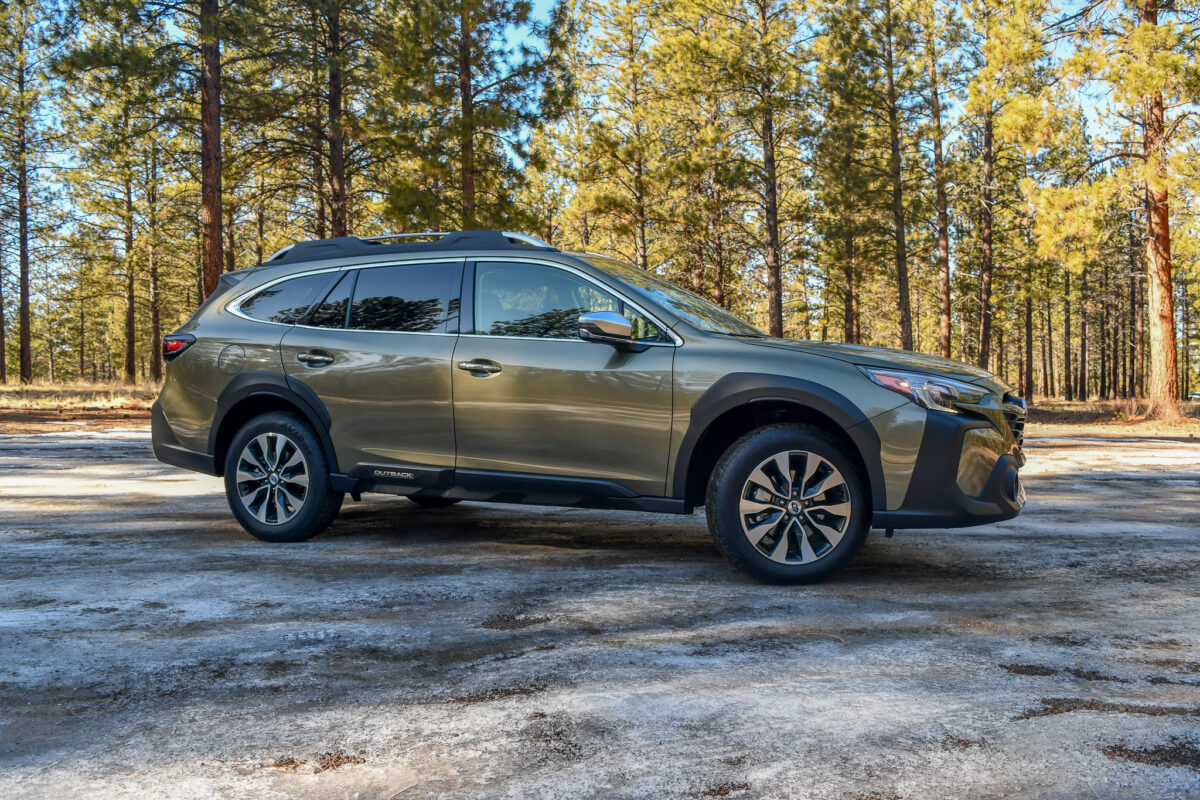 The Side Profile Of A 2024 Subaru Outback Touring Xt In A Wooded Dirt Lot