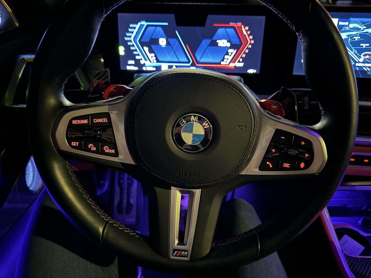 The Steering Wheel And Cabin Light Up At Night In The 2024 Bmw X5 M