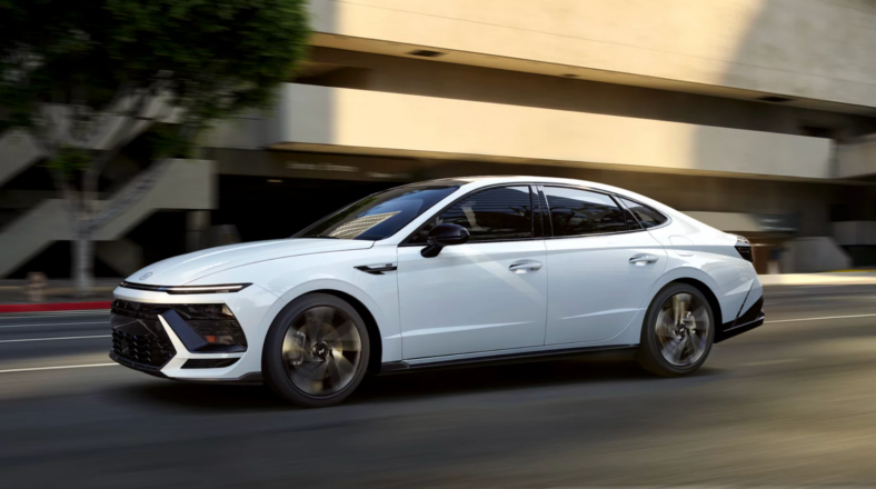 The 2025 Hyundai Sonata Sedan Driving Down A Busy Street