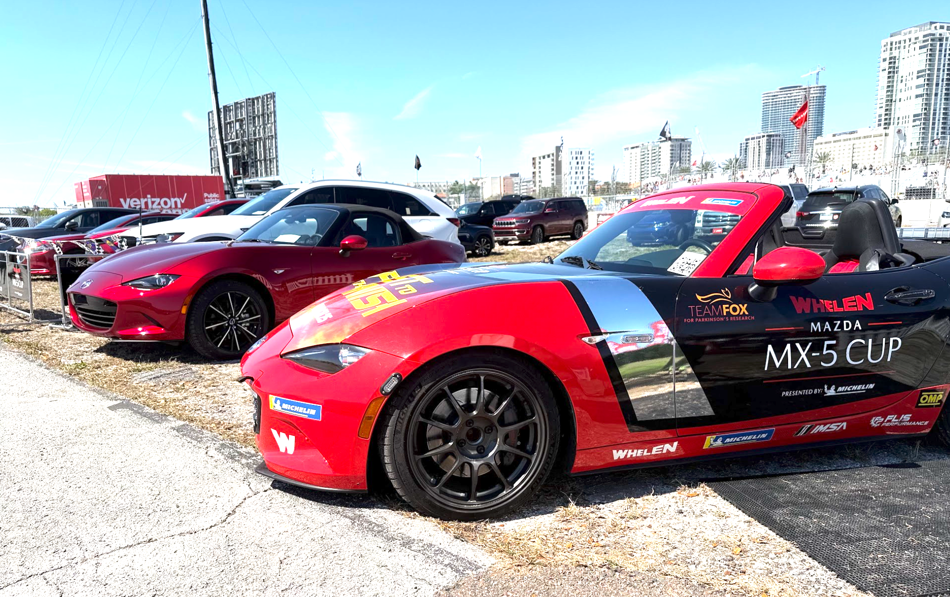 A Standard Mazda Miata Mx-5 And A Promotional Car To The Left Of It