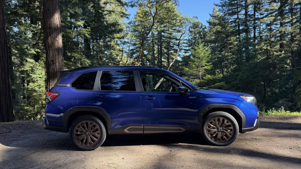 The Side Profile Of The 2025 Subaru Forester Hybrid Parked In A Wooded Area