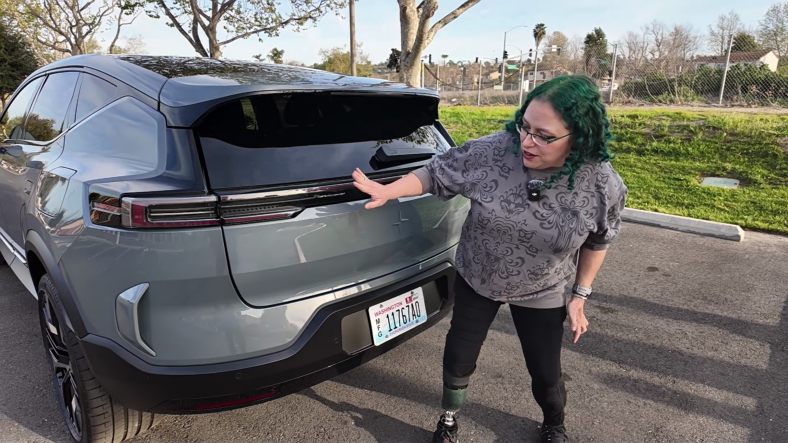 EV Innovation Meets Inclusivity: How the 2025 Polestar 3 Caters to All Drivers 4 Liv Leigh Standing At The Rear Of The Polestar 3, Discussing The Adaptive Taillights