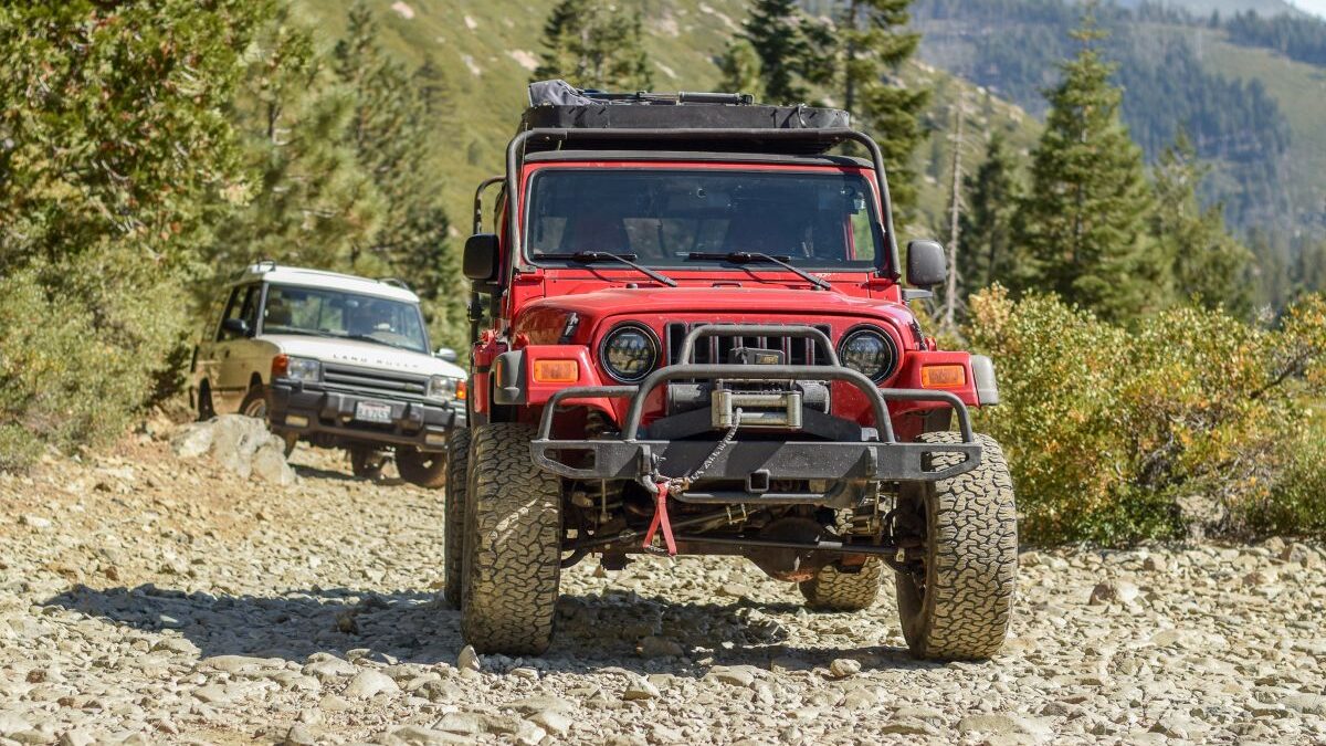 A 2006 Jeep Wrangler And A 1996 Land Rover Discovery Traversing A Trail
