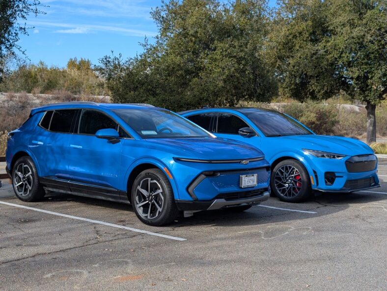 The Equinox EV parked next to a Mustang Mach-E