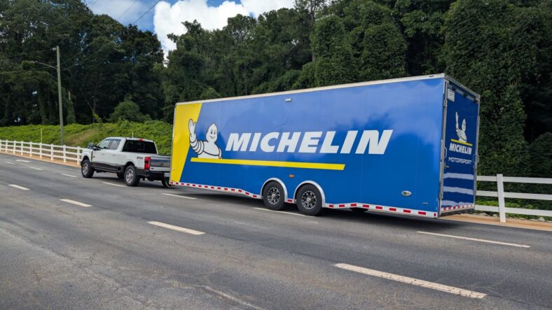 A Ford F-350 Towing A Race Car Trailer