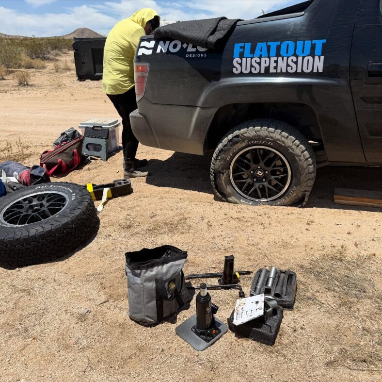 Jill'S Teammate Dealing With A Flat Tire On The Rebelle Rally Training