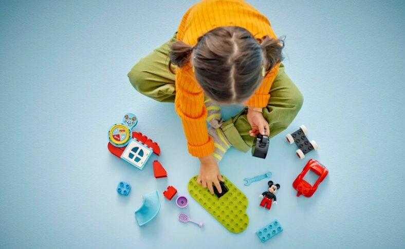 A Young Girl Playing With The Mickey Mouse Club House Club Car