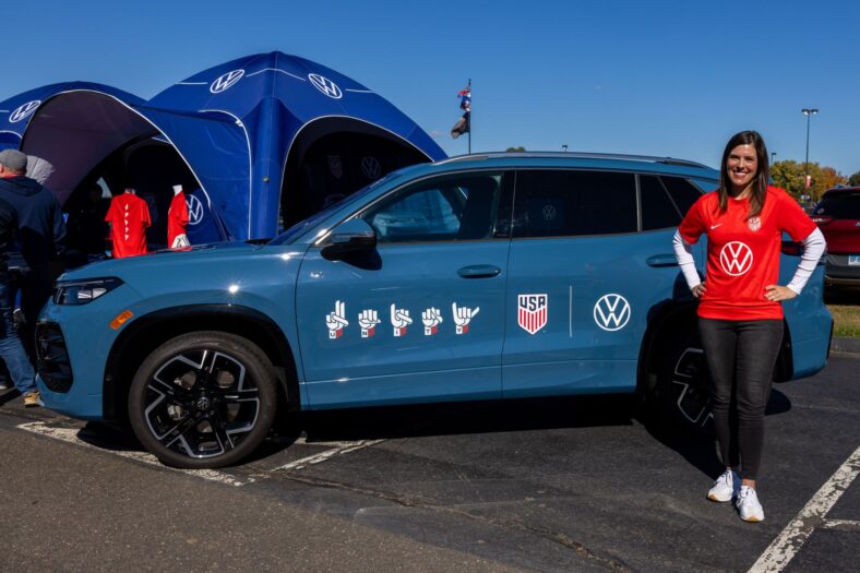 Remy Block Standing With A Vw Tiguan With Decals Featuring Her Design